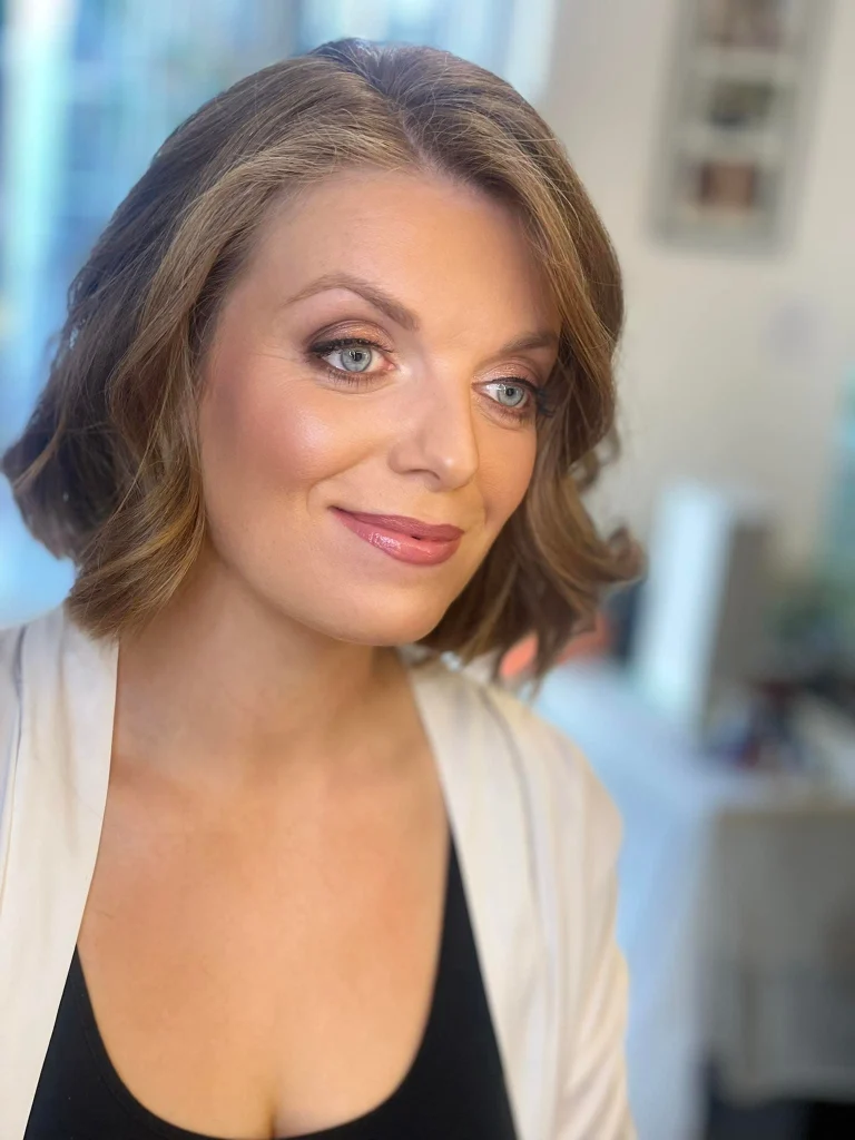 Bride with luminous complexion, rosy cheeks, and subtle eye makeup.