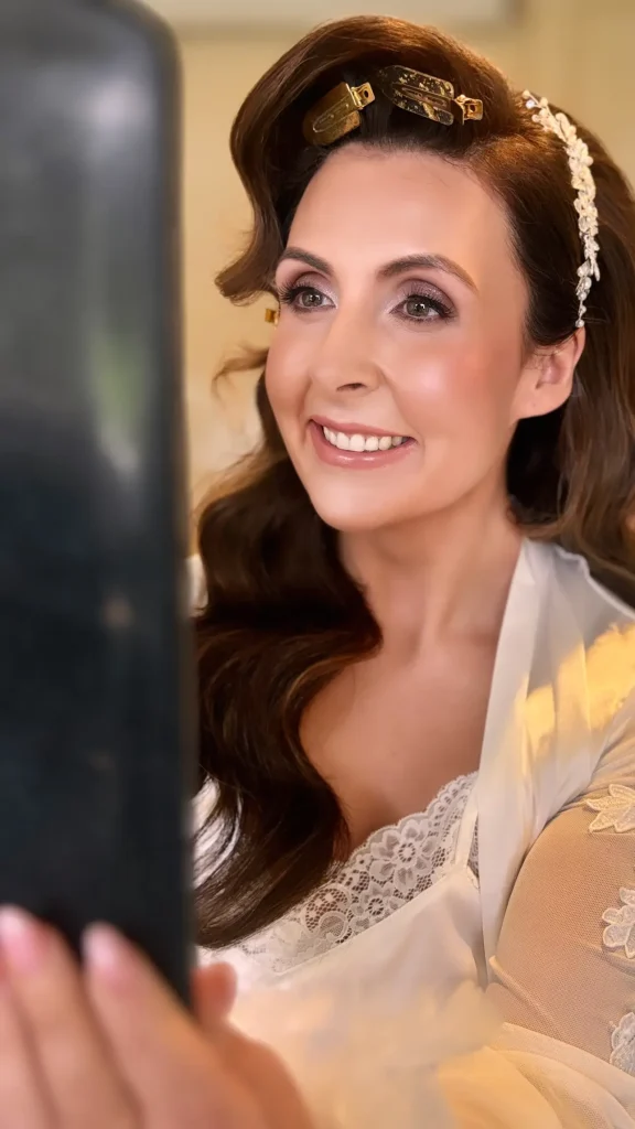 Bride admiring her wedding makeup in a mirror