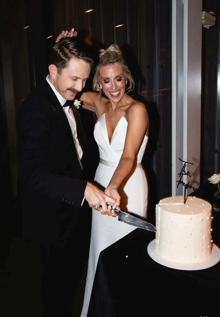 American bride cutting the cake with her groom on their wedding day in Ireland