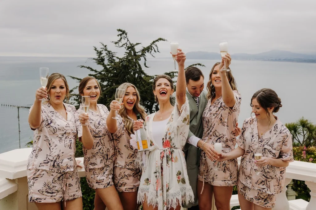 Destination bridal party cheersing with champagne