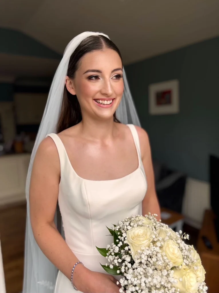Smiling bride in a classic white wedding dress