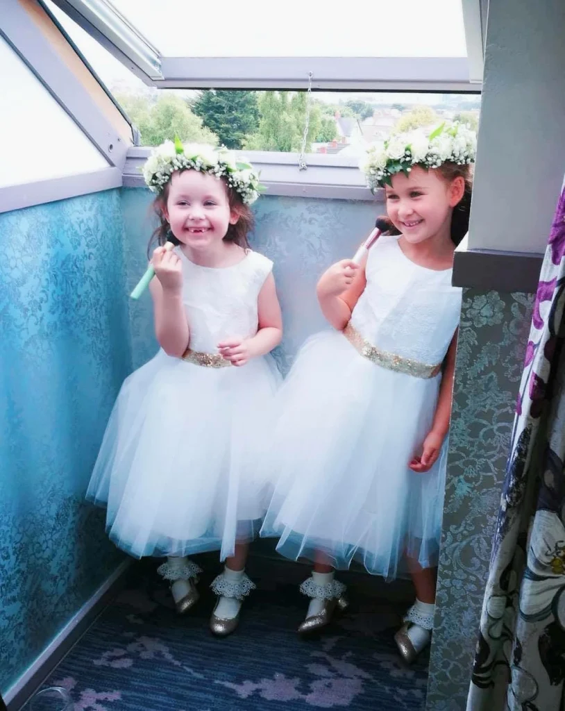Two flower girls holding brushes