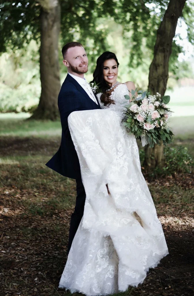 Groom carrying his beautiful bride - wedding makeup done by Nima