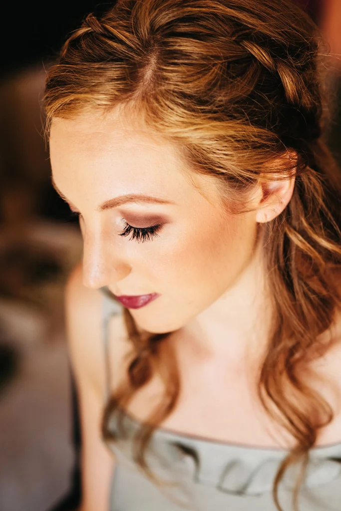 Woman looking down to reveal glam makeup