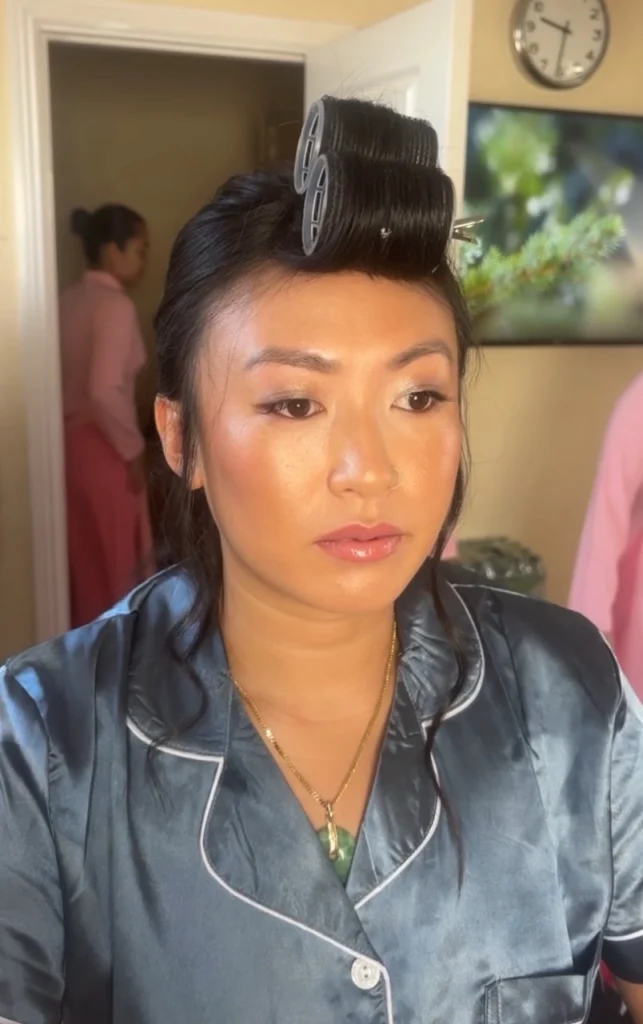 Woman with rollers in her hair and makeup ready